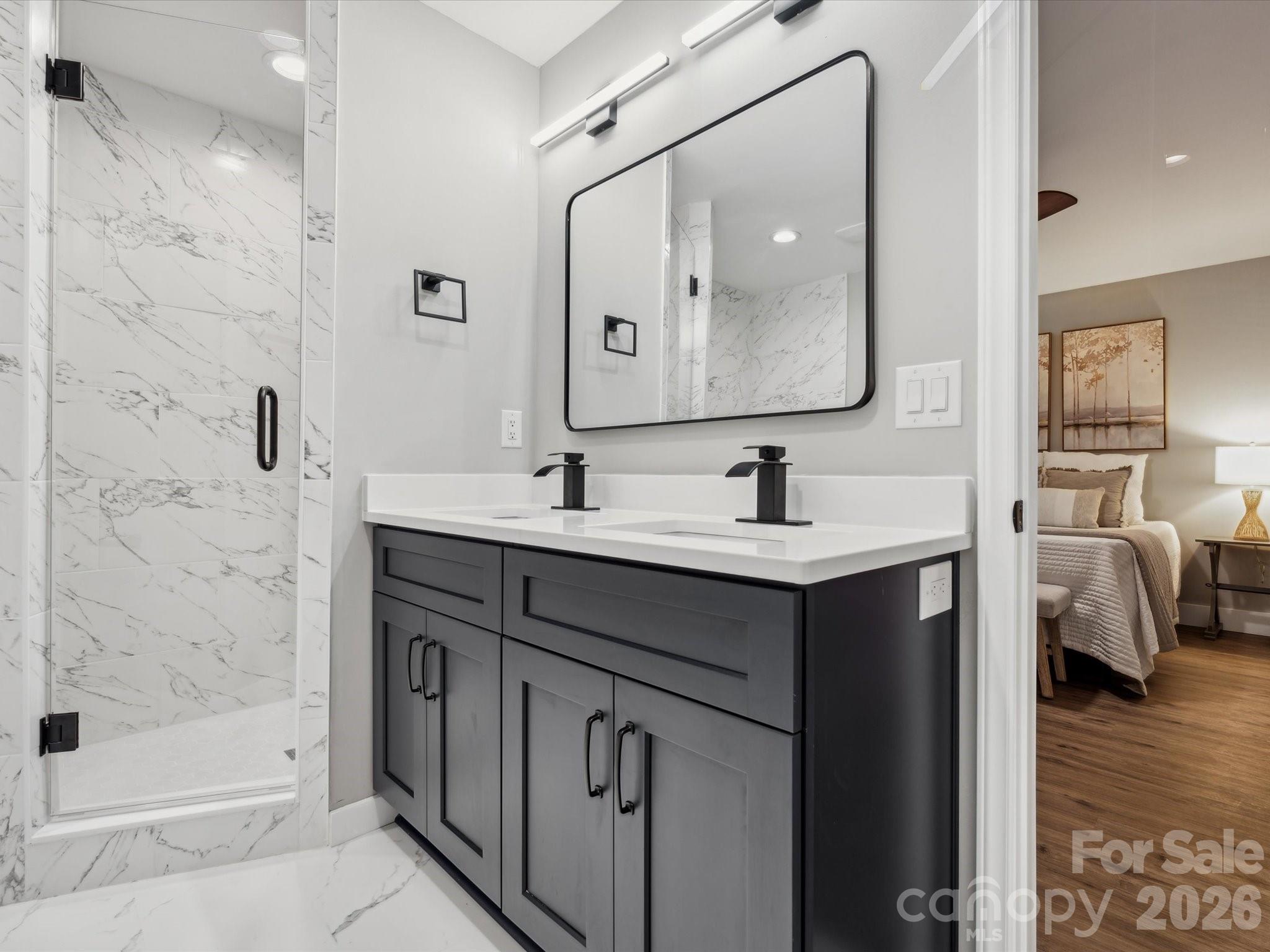 2000 Tyvola Road Charlotte, NC 28210 - Photo 25 of 32 a bathroom with a sink double vanity and shower