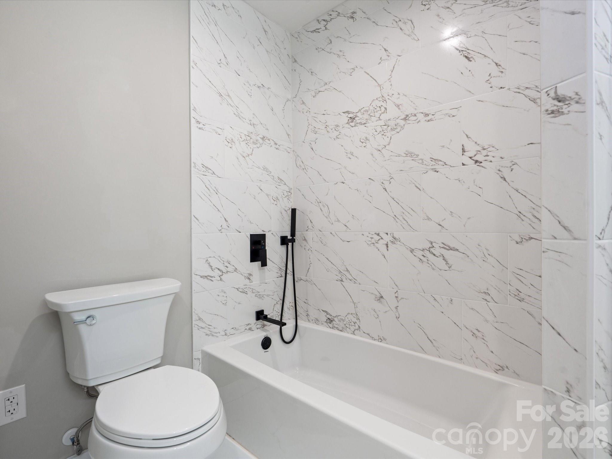2000 Tyvola Road Charlotte, NC 28210 - Photo 26 of 32 a white toilet sitting next to a bath tub