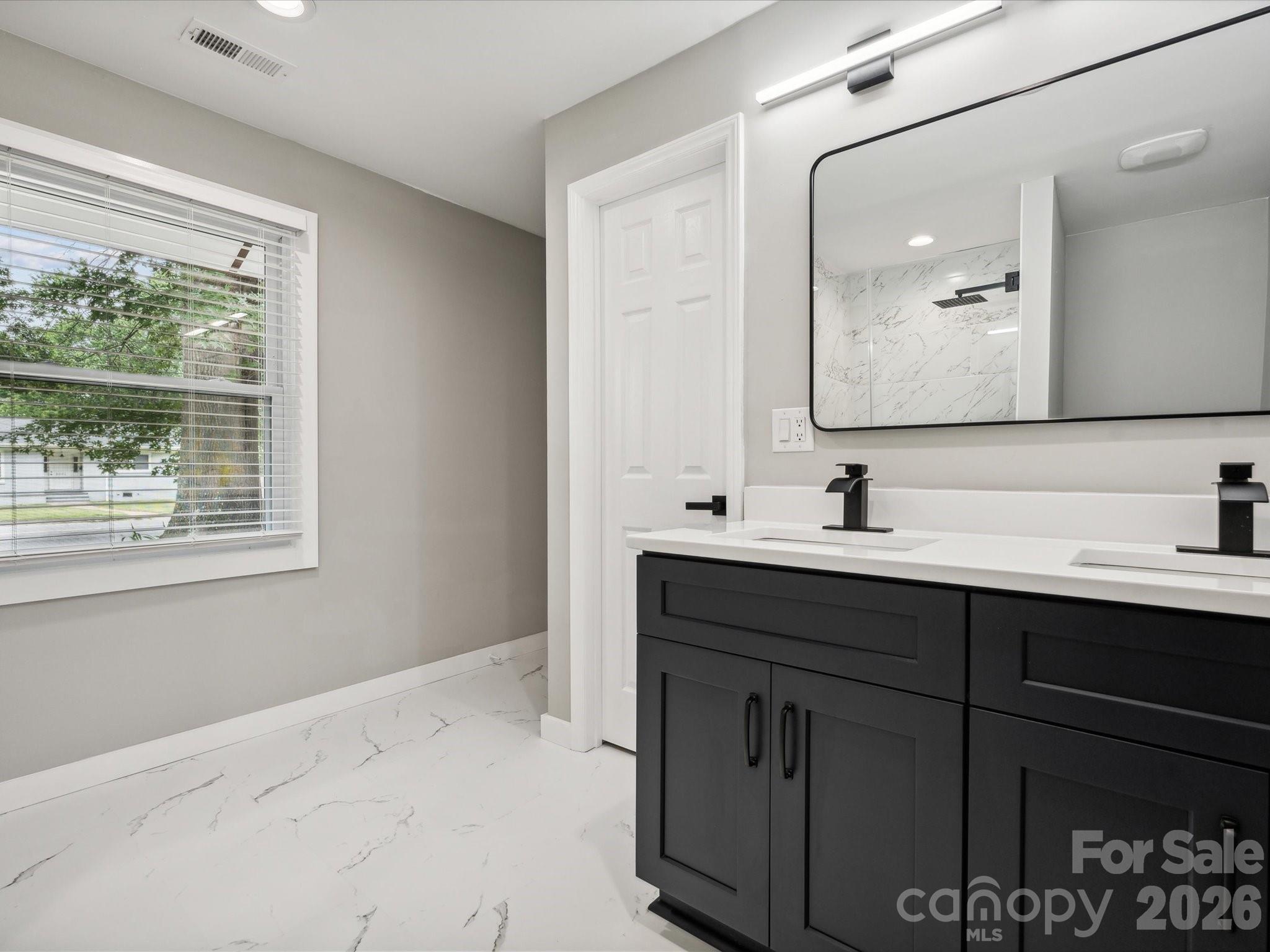 2000 Tyvola Road Charlotte, NC 28210 - Photo 29 of 32 a bathroom with a sink and a mirror