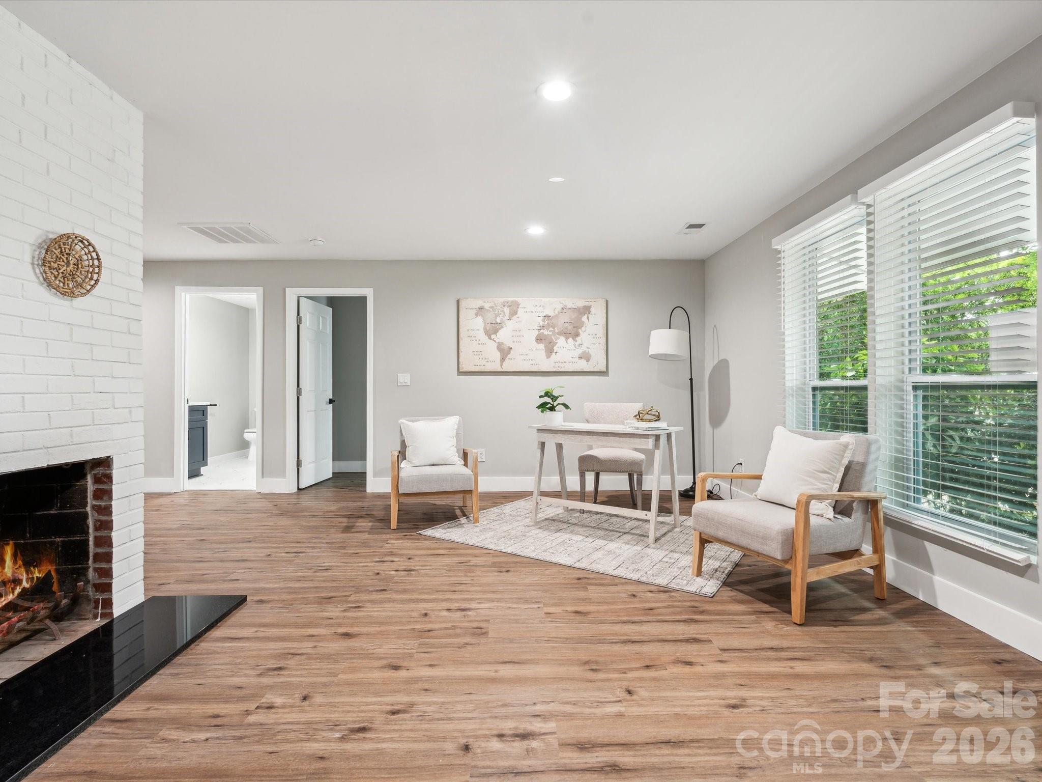 2000 Tyvola Road Charlotte, NC 28210 - Photo 4 of 32 a living room with furniture and a fireplace