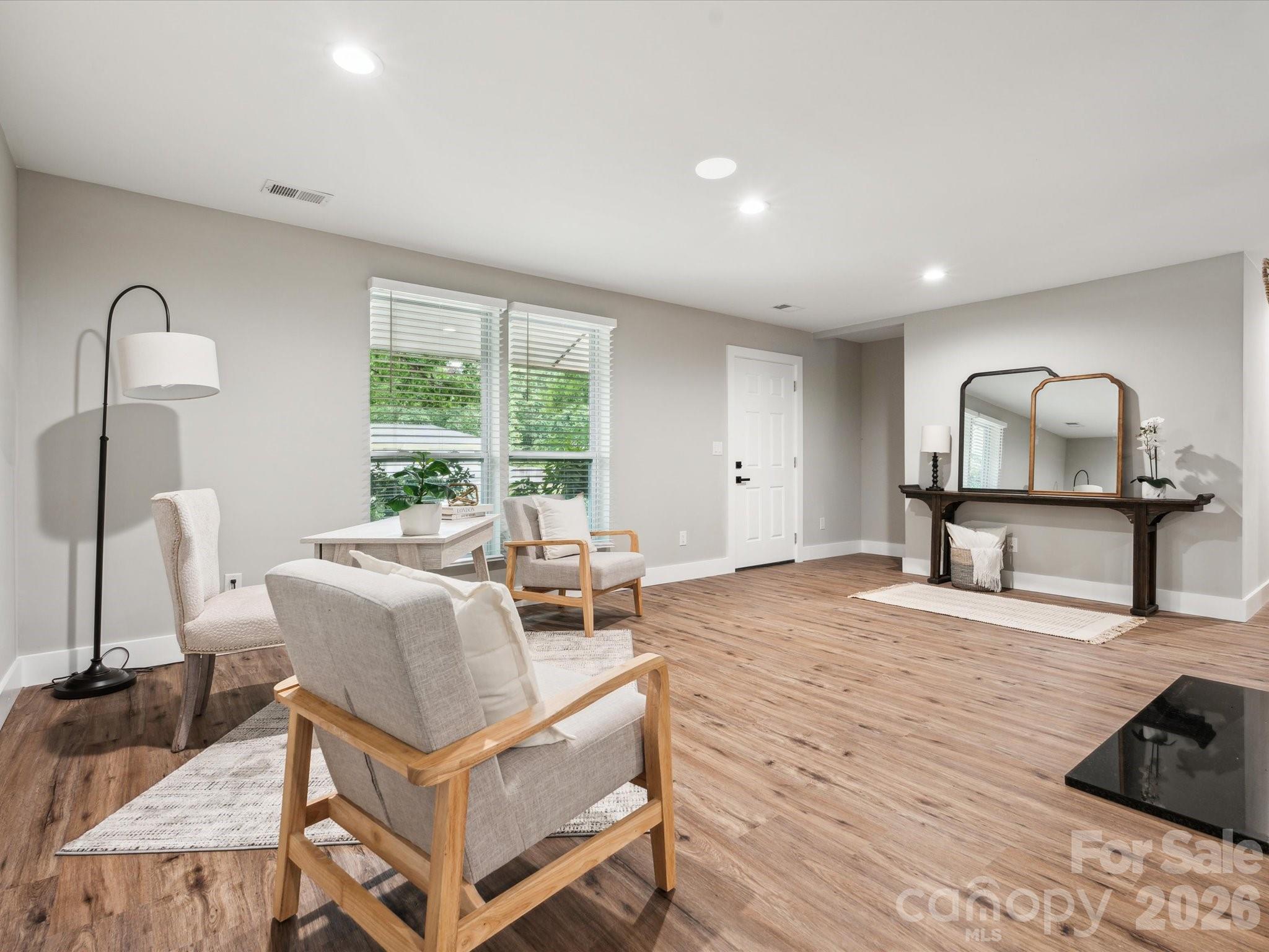 2000 Tyvola Road Charlotte, NC 28210 - Photo 5 of 32 a living room with furniture a window and a flat screen tv