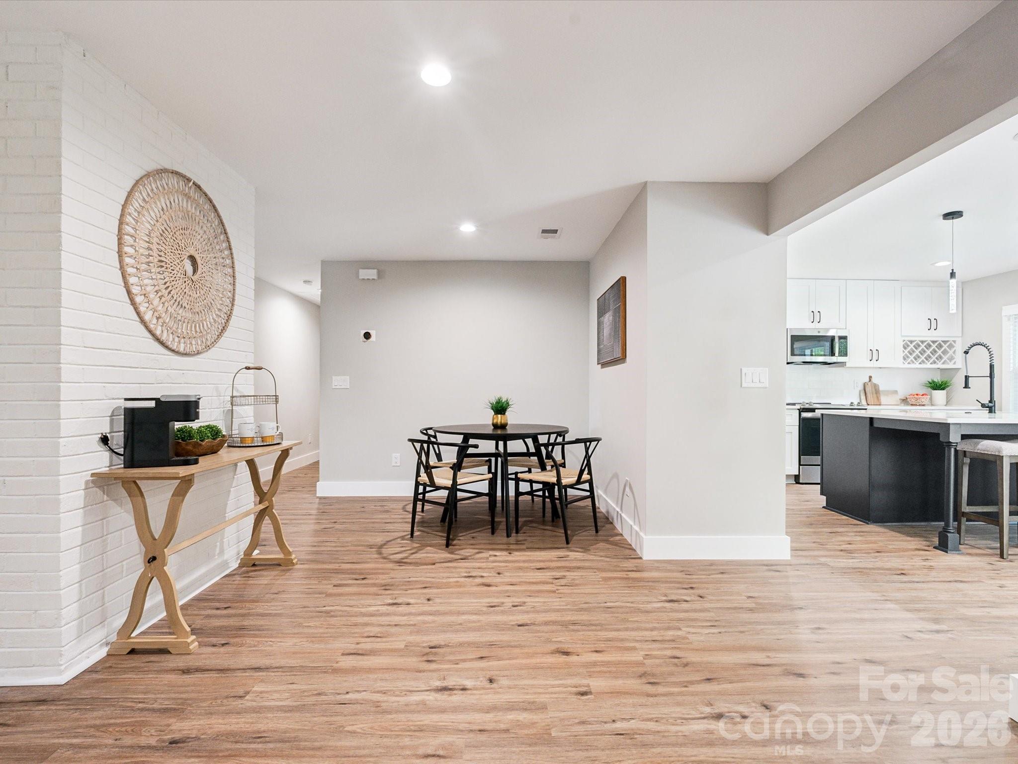 2000 Tyvola Road Charlotte, NC 28210 - Photo 8 of 32 a view of a dining room with furniture and wooden floor