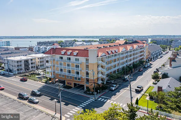 an aerial view of a building with streets and trees