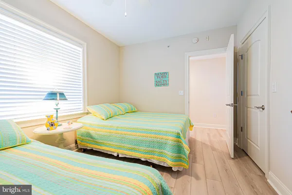 a bedroom with a bed and a large window