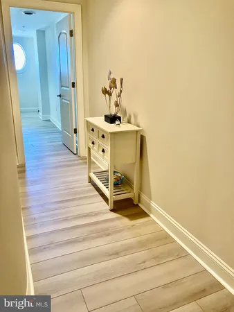 a room with wooden floor and staircase