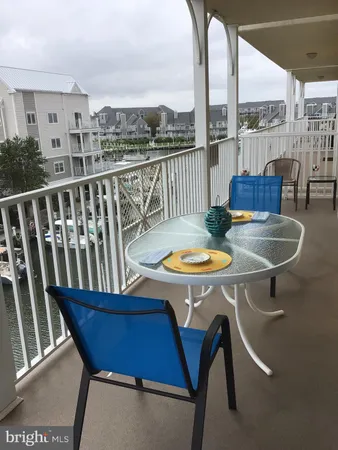 a view of a balcony dining table and chairs