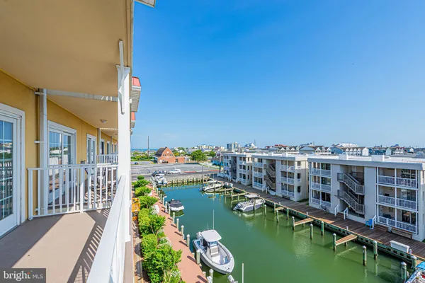 a view of residential houses with outdoor space and lake view