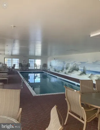 a kitchen with a table chairs stove and cabinets