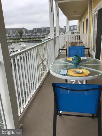 a view of a balcony with chair and wooden floor