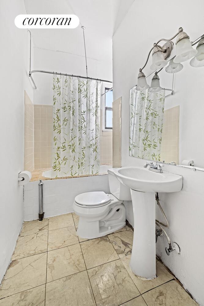 175 Claremont Avenue, Unit 61 Manhattan, NY 10027 - Photo 5 of 7 a bathroom with a sink a toilet and shower