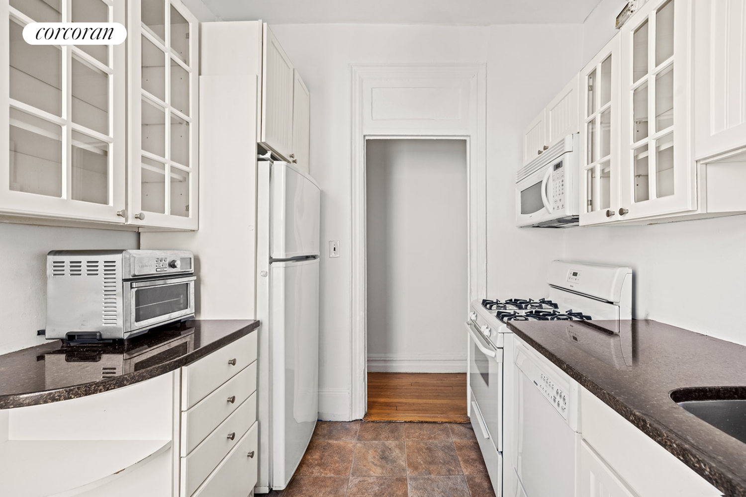 175 Claremont Avenue, Unit 61 Manhattan, NY 10027 - Photo 6 of 7 a kitchen with stainless steel appliances granite countertop a refrigerator and a sink