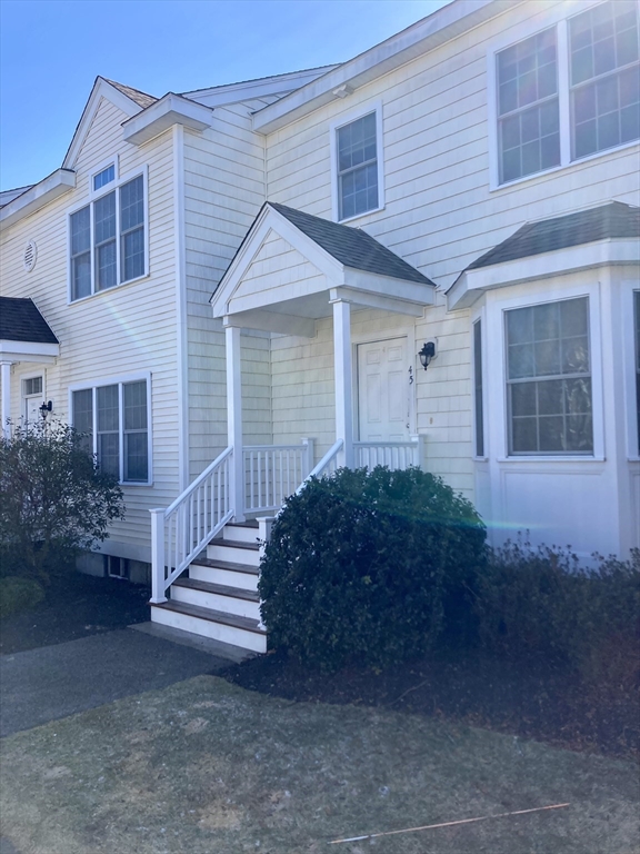 45 Turtle Brook Road, Unit 45 Canton, MA 02021 - Photo 13 of 14 a front view of a house with a garden