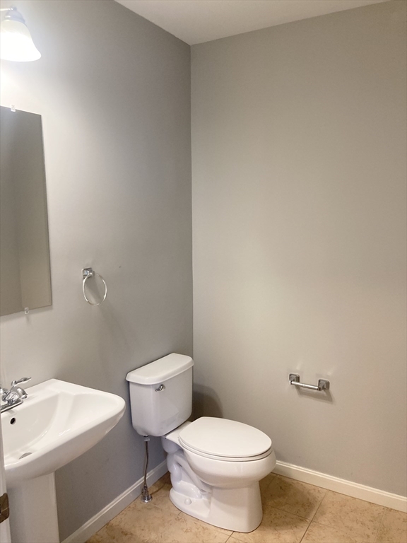 45 Turtle Brook Road, Unit 45 Canton, MA 02021 - Photo 5 of 14 a white toilet sitting next to a bathroom sink