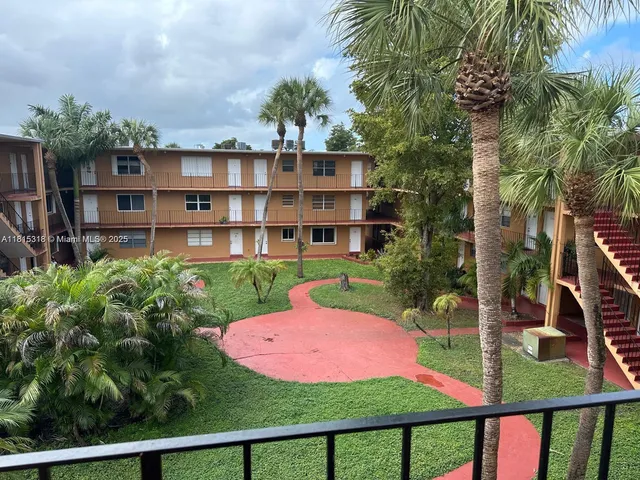 a view of a garden with a house