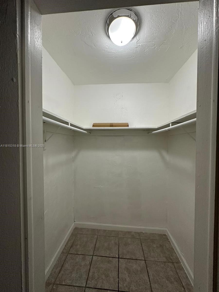 1230 West 54th Street, Unit 325A Hialeah, FL 33012 - Photo 7 of 10 a view of a room with shelf