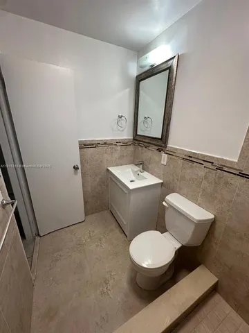 a bathroom with a toilet sink and shower
