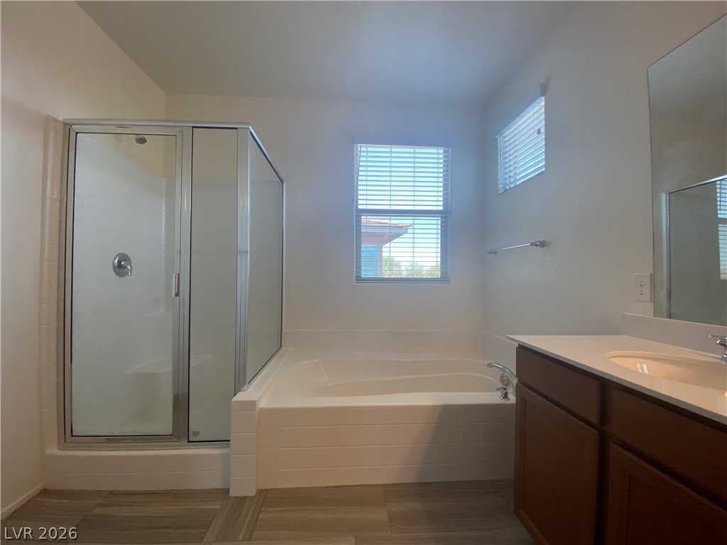 436 Cadence View Way Henderson, NV 89011 - Photo 29 of 36 Luxurious bathing quarters with a separate shower and generous soaking tub, offering a tranquil escape.