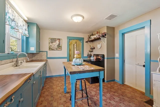 a view of a kitchen area with furniture and stove
