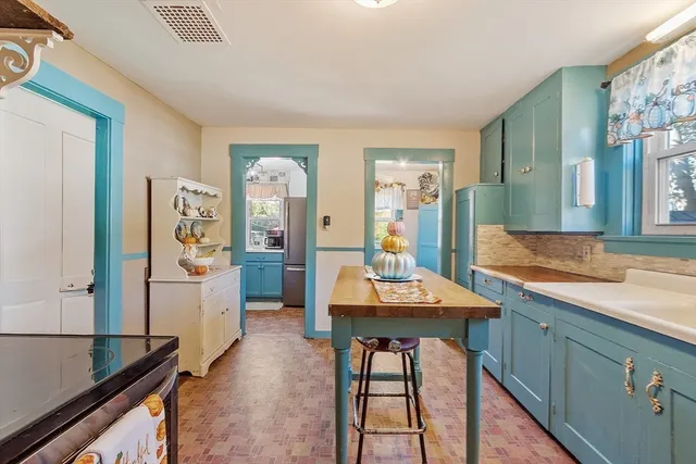 a view of a a dining room with furniture and a chandelier