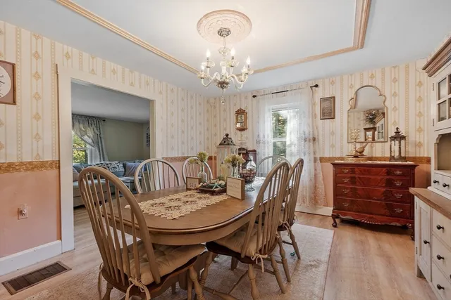 a living room with furniture flat screen tv and a large window