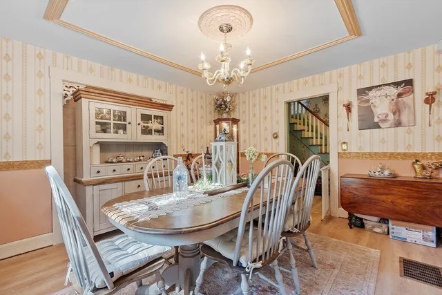 a living room with furniture a large window and a table