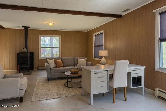 a living room with furniture a fireplace and a window