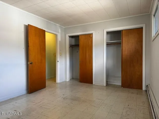 an empty room with closet and wooden door