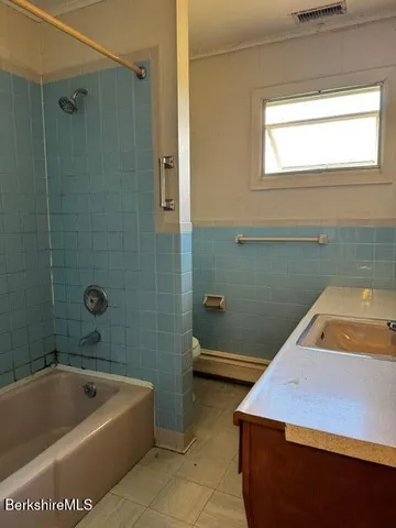 a bathroom with a sink and bathtub