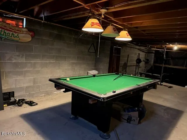 a room with pool table and windows