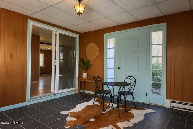 a dining room with furniture and window