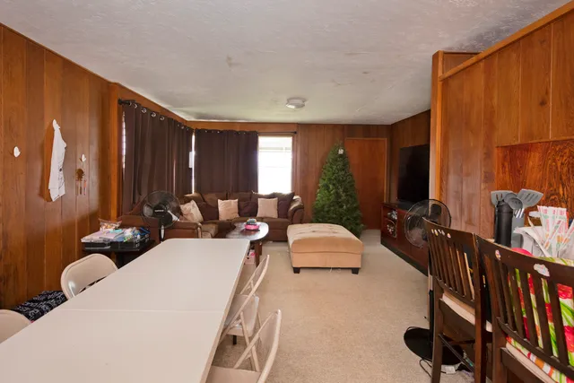 a living room with furniture a lamp and a large window