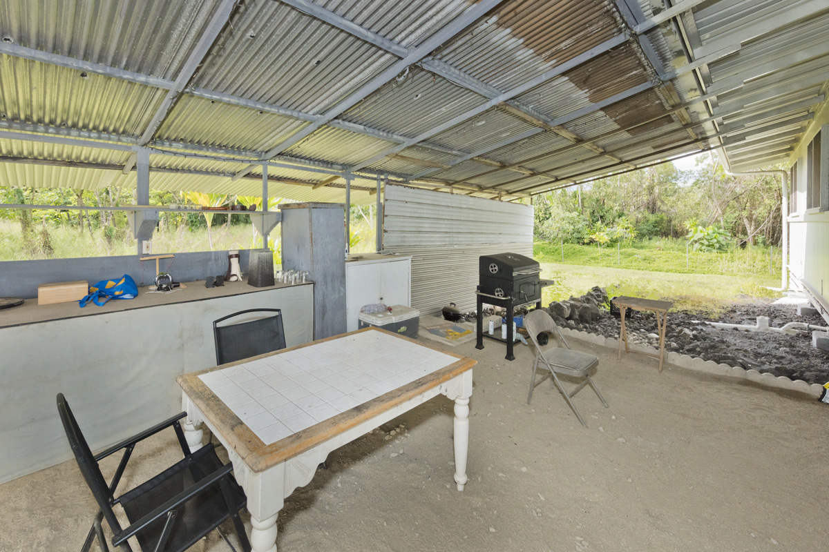 360 A Lama Street Hilo, HI 96720 - Photo 10 of 28 a kitchen with a table chairs stove and sink