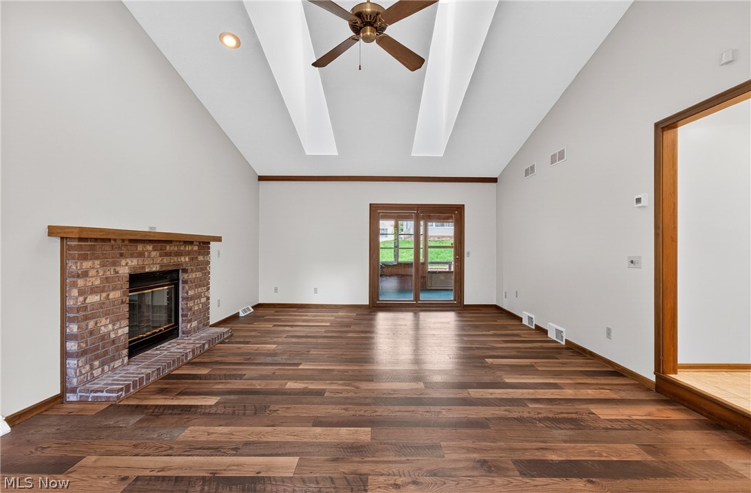 5346 Burlawn Street Northwest Canton, OH 44708 - Photo 5 of 40 Spacious living area featuring a vaulted ceiling with decorative wood beams and a ceiling fan