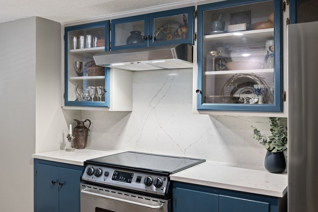 3500 Enfield Road, Unit E Austin, TX 78703 - Photo 20 of 40 The lavish quartz flows from the countertops to the backsplash, defining the kitchen's sophisticated aesthetic.