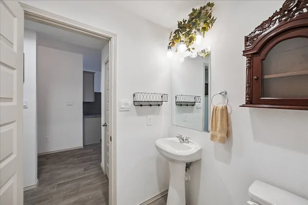 a bathroom with a sink toilet and mirror