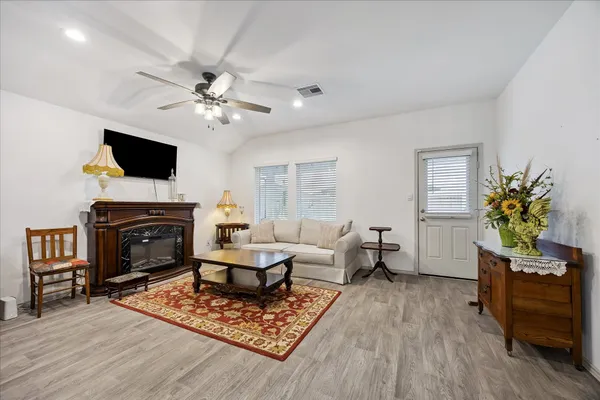 a living room with furniture a fireplace and a flat screen tv