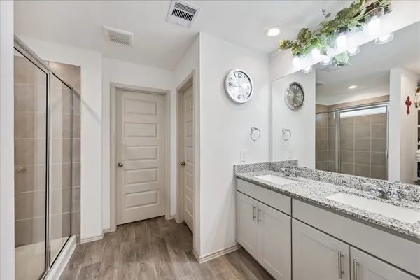 a spacious bathroom with a granite countertop sink and a mirror