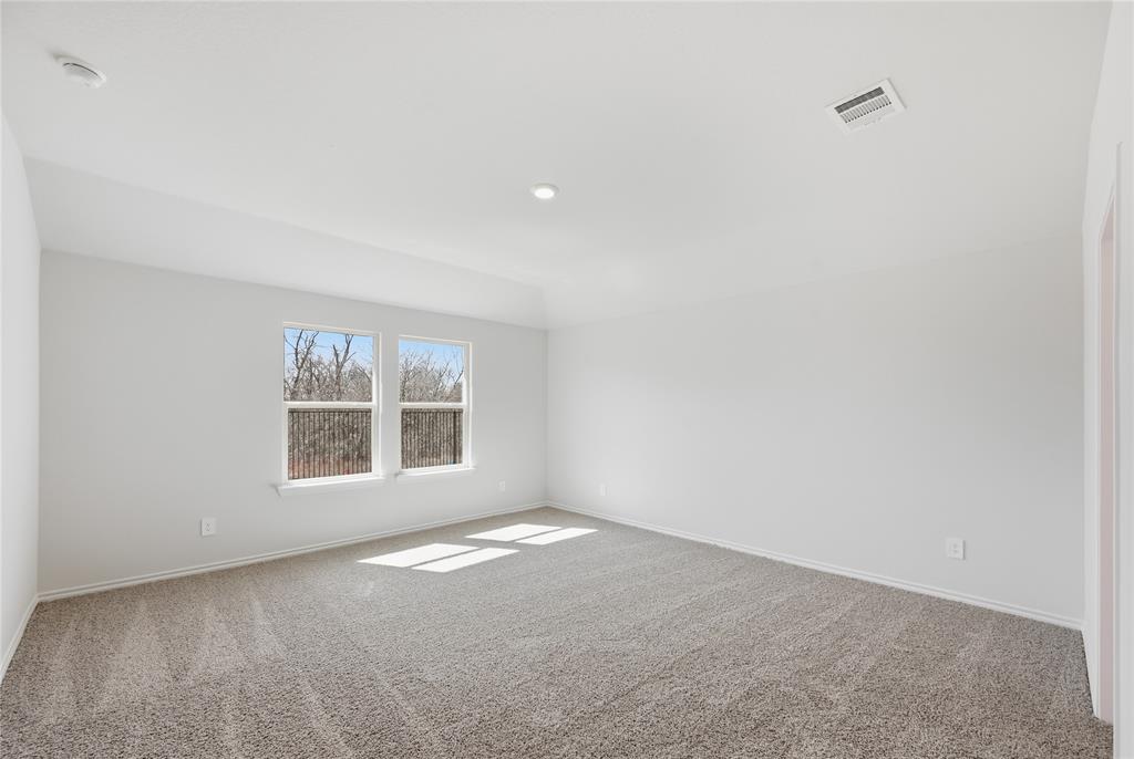 1905 Reveille Way Terrell, TX 75160 - Photo 6 of 6 Spacious room featuring neutral carpeting, light-colored walls, and two large windows offering views of exterior trees