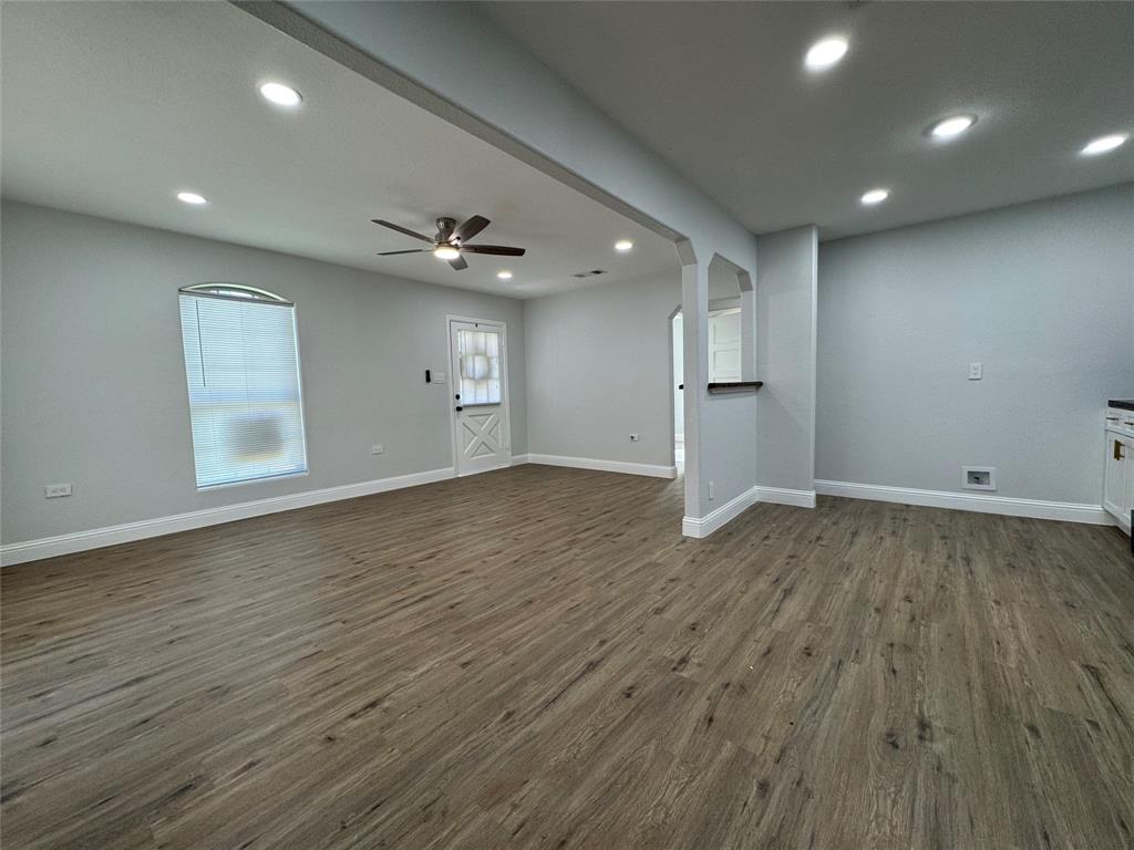 2909 Alexander Avenue Waco, TX 76708 - Photo 4 of 27 an empty room with wooden floor and windows
