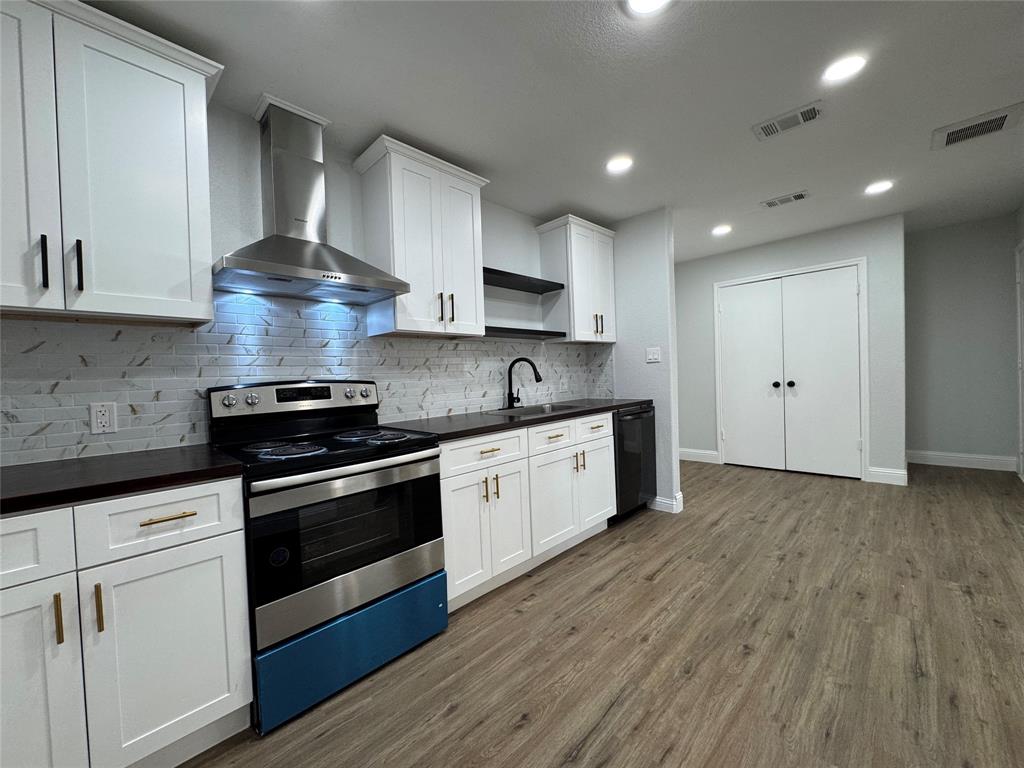 2909 Alexander Avenue Waco, TX 76708 - Photo 8 of 27 a kitchen with stainless steel appliances granite countertop a stove a sink and a refrigerator