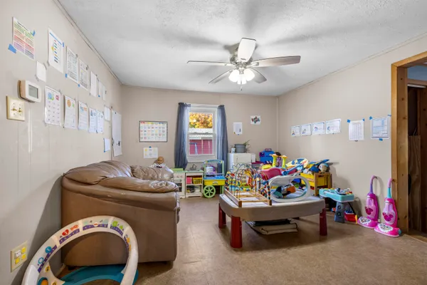 a bedroom with bed and a wooden floor