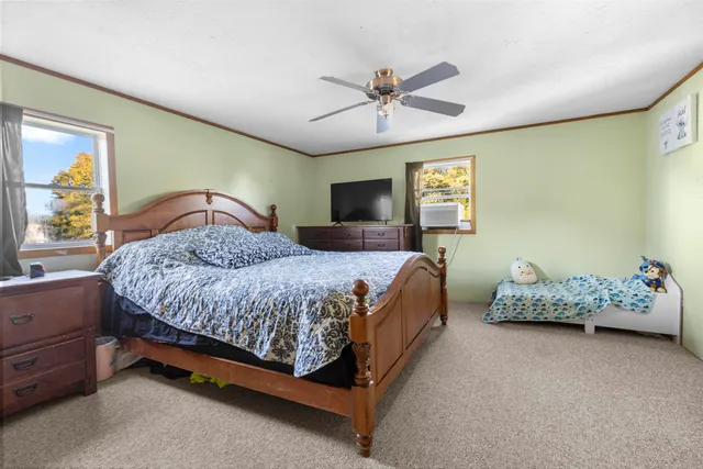 a bedroom with a bed and a window