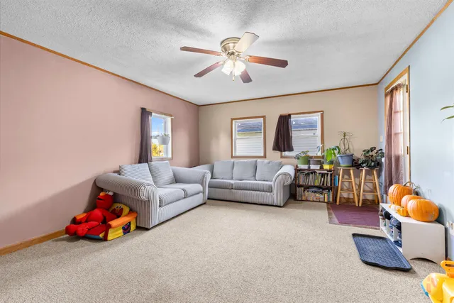 a living room with furniture and a chandelier