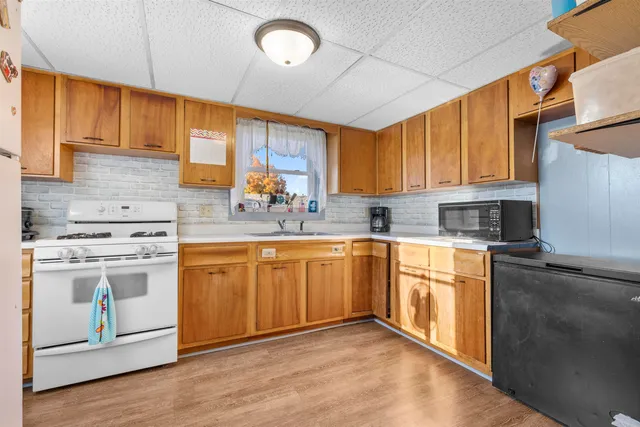 a kitchen with stainless steel appliances granite countertop a sink stove and cabinets
