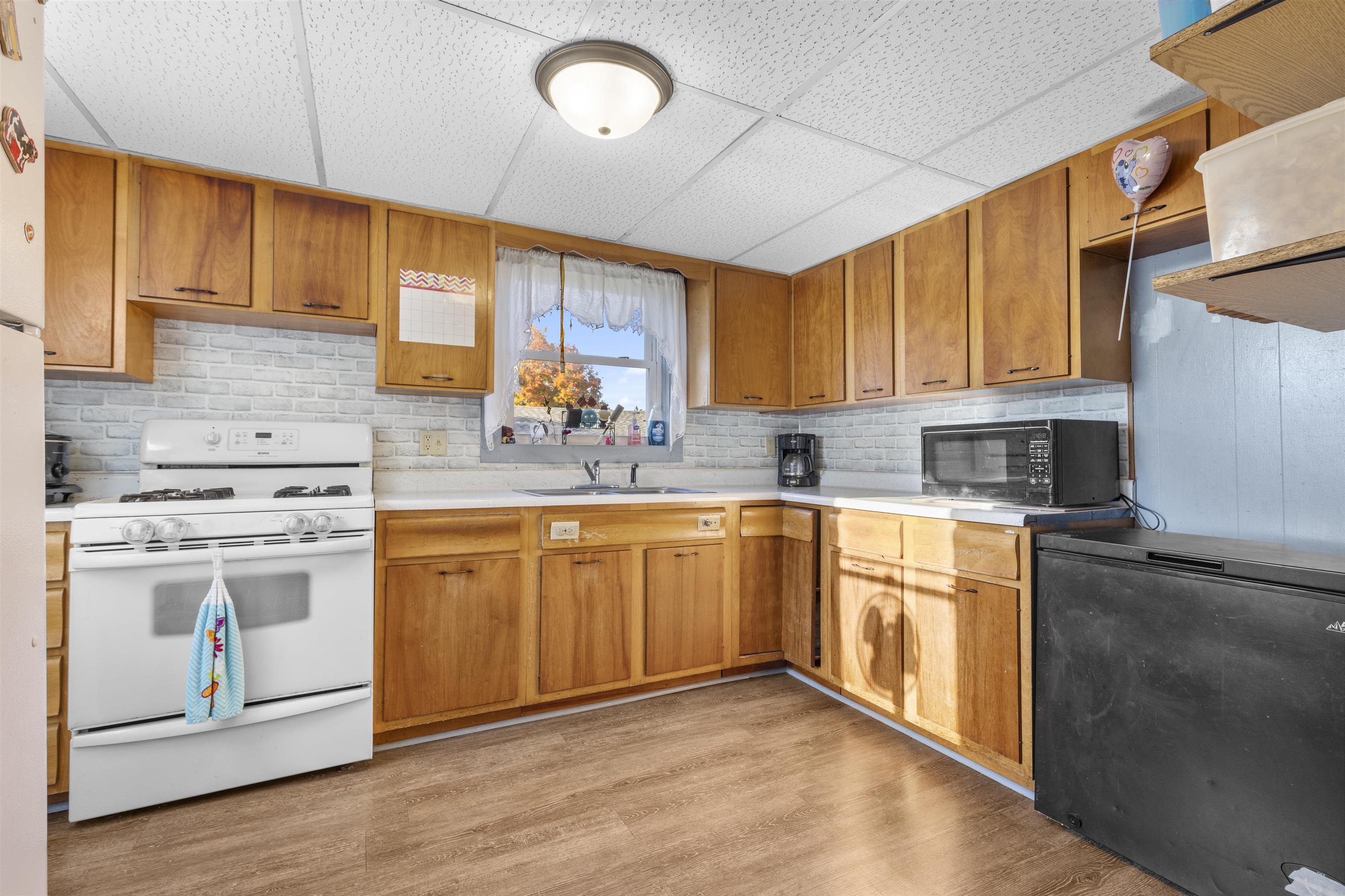 411 South Walnut Avenue Forreston, IL 61030 - Photo 7 of 19 a kitchen with stainless steel appliances granite countertop a sink stove and cabinets