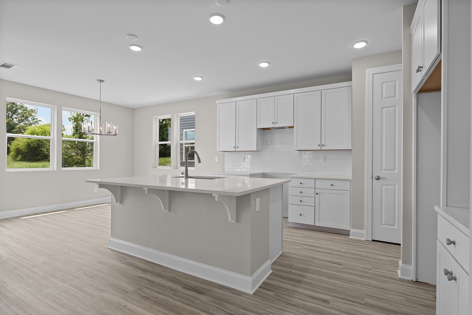 127 Timber Crest Trail White Bluff, TN 37187 - Photo 5 of 22 a kitchen with stainless steel appliances granite countertop a sink a stove a refrigerator and white cabinets with wooden floor