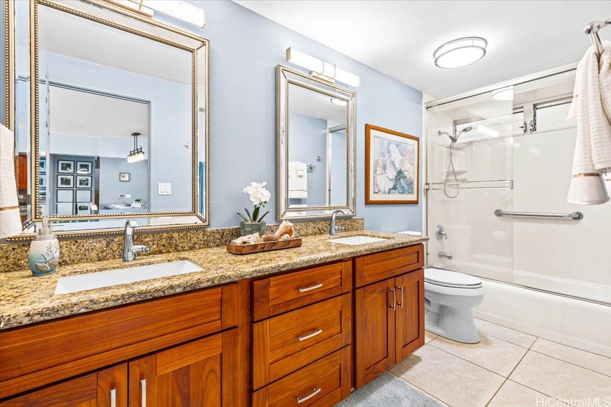 2161 Kalia Road, Unit 402 Honolulu, HI 96815 - Photo 15 of 25 a bathroom with a granite countertop double vanity sink a mirror and a toilet