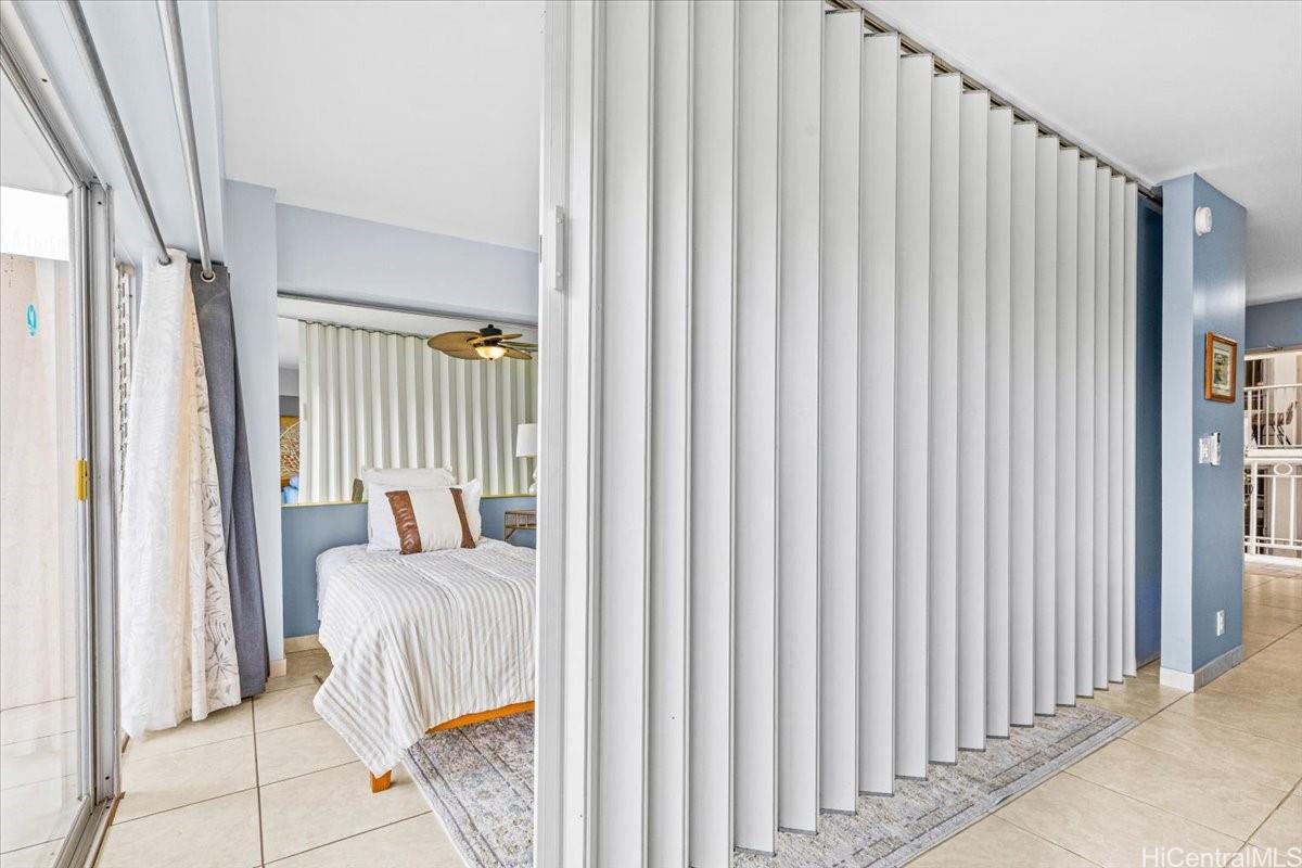 2161 Kalia Road, Unit 402 Honolulu, HI 96815 - Photo 17 of 25 a view of a bedroom with wooden floor and furniture