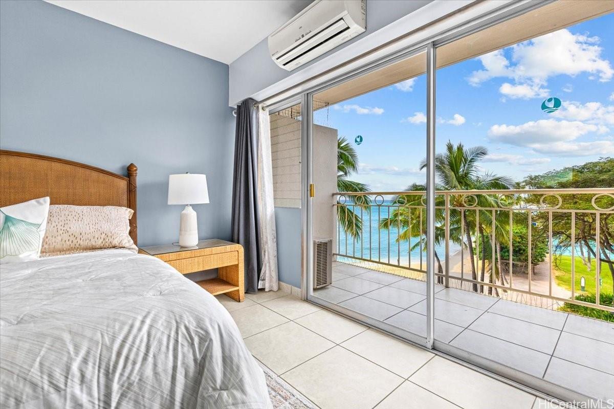 2161 Kalia Road, Unit 402 Honolulu, HI 96815 - Photo 23 of 25 a bedroom with a bed and a chandelier