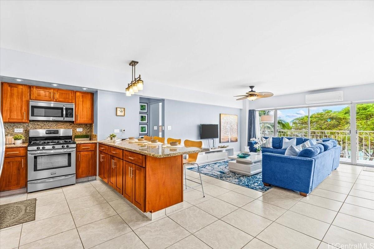 2161 Kalia Road, Unit 402 Honolulu, HI 96815 - Photo 6 of 25 a large kitchen with stainless steel appliances granite countertop a stove and a view of living room
